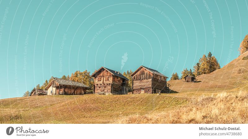 Three alpine huts on the slope in pastel South Tyrol mountains Alps Clouds alpine panorama Dramatic Idyll idyllically Moody hike hill clouds dramatic mood sky