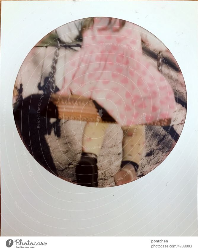 A colorfully dressed child on a swing. Polaroid. Nostalgia. Childhood variegated Swing colourful Infancy Playground To swing Playing Joy Exterior shot