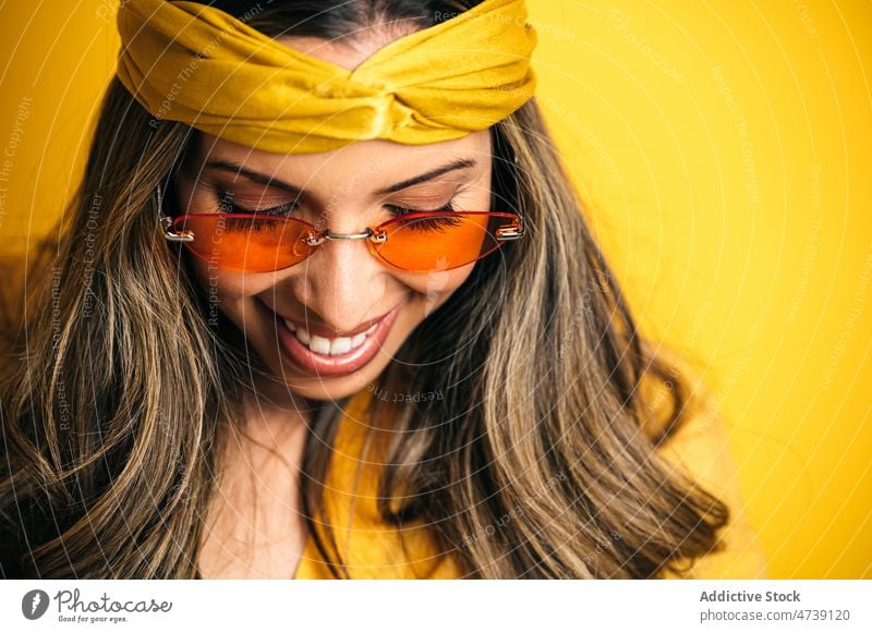 Smiling stylish woman in trendy sunglasses and headband model individuality happy appearance cool feminine style portrait female editorial vibrant vivid eyewear