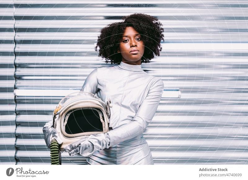 Black woman in astronaut costume spacesuit helmet spaceship cosmonaut mission uniform modern safety african american black light lady confident creative