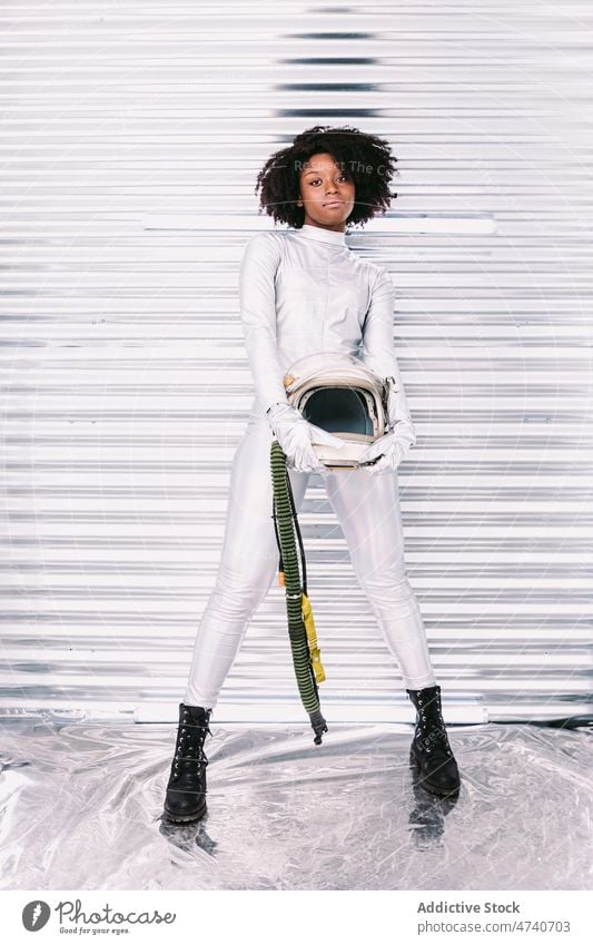 Black woman in astronaut costume spacesuit helmet spaceship cosmonaut mission uniform modern safety african american black light lady confident creative