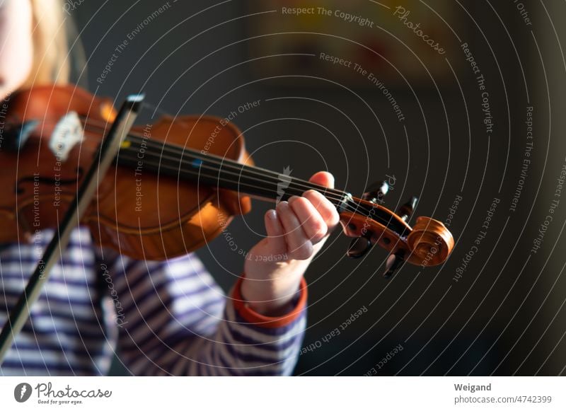 Child with violin in hand playing music Music Violin upbringing Girl Melody Gratitude Sound string instrument notes Song music school Make music Playing