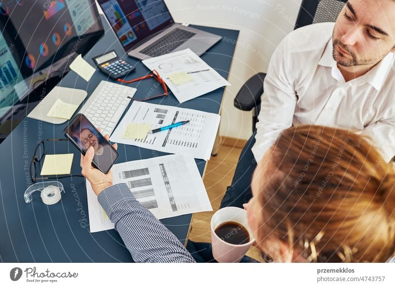 Business colleagues having video call discussing financial data working together in office. People entrepreneurs working with charts and tables on computer. Team working together