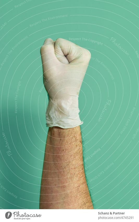 Fist with rubber glove against monochrome background Arm Business Gloves Close-up colored background Copy Space price detail Thumb Unicoloured Fingers