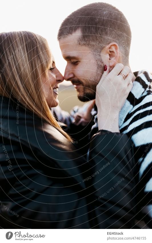 Close up couple nose kissing in the countryside embraced. Boyfriend and girlfriend in love close up hugging two people embracing journey weekend man woman adult