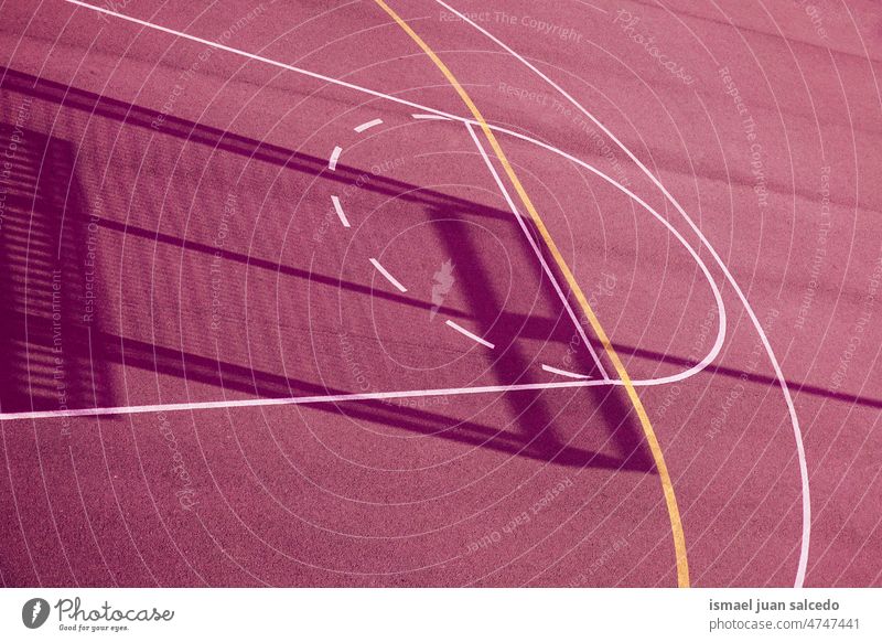 shadows on the red street basket court basketball sport field empty lines markings ground play playing old park playground outdoors background bilbao spain