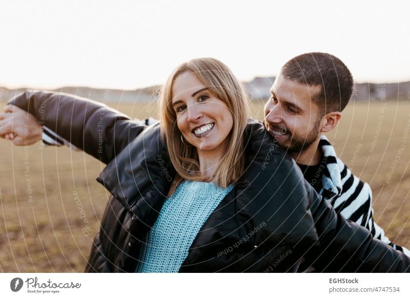 Young couple dancing outdoor through meadow in countryside. Boyfriend and girlfriend in love ourney weekend people man woman adult nature outdoors affectionate