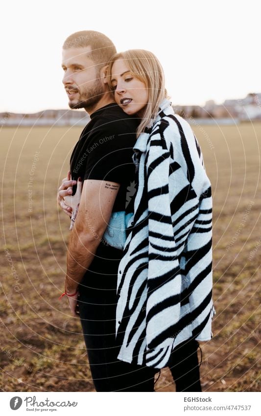 Couple kissing in the countryside embraced. Boyfriend and girlfriend in love hug hugging couple embracing journey weekend people man woman adult nature outdoors