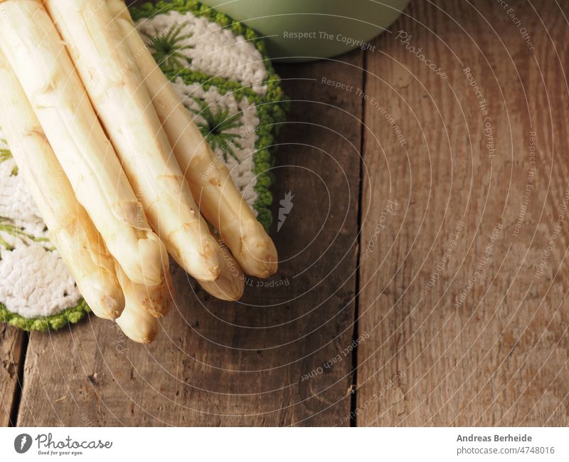 Tasty fresh organic asparagus on a rustic wooden table, white raw food bunch background diet ingredient spring season healthy natural vegetable gourmet