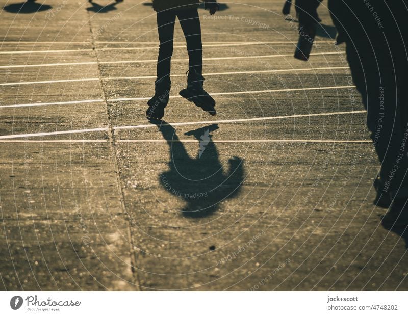 Silhouette of child riding rollerblades Human being Shadow Neutral Background Lanes & trails Sunlight Shadow play Back-light Structures and shapes Serene Moody