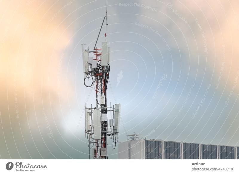 Telecommunication tower near building. Antenna. Radio and satellite pole on gray sky. Communication technology. Telecommunication industry. Mobile or telecom 4g network. Telecommunication industry.