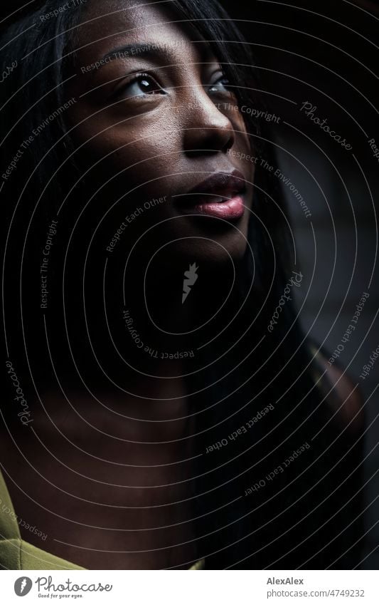 Young beautiful long haired woman standing in dark room looking up to the light Woman Young woman pretty Beauty & Beauty Graceful Friendliness PoC Long-haired