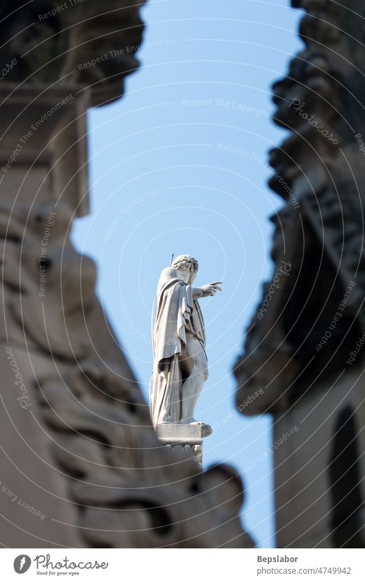 Statue on the spire Italy above architecture cathedral church commemorative faith high historic holiness holy isolated milano monument religion sculpt sculpture