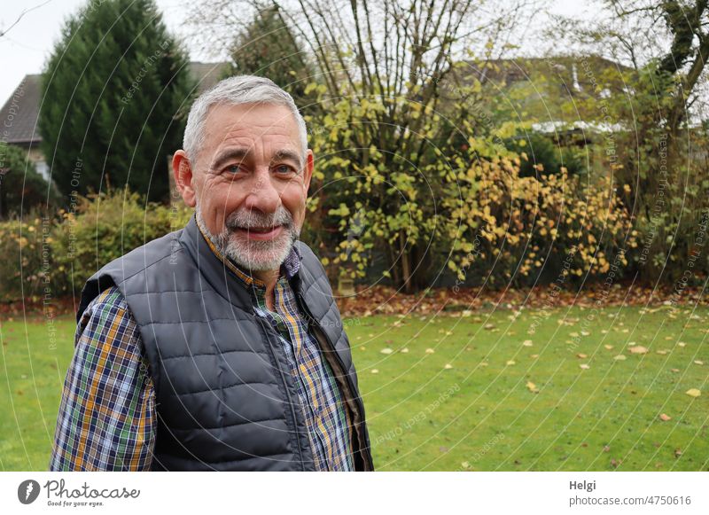 Portrait of senior citizen standing in garden and smiling Human being Man Senior citizen portrait Gray-haired Short-haired Facial hair Smiling Friendliness kind