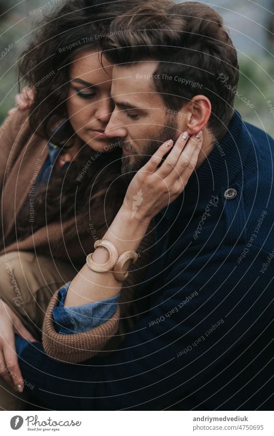 portrait of two caucasian lovers. Young couple is hugging on autumn day outdoors. A bearded man and curly woman in love. Valentine's Day. Concept of love and family.