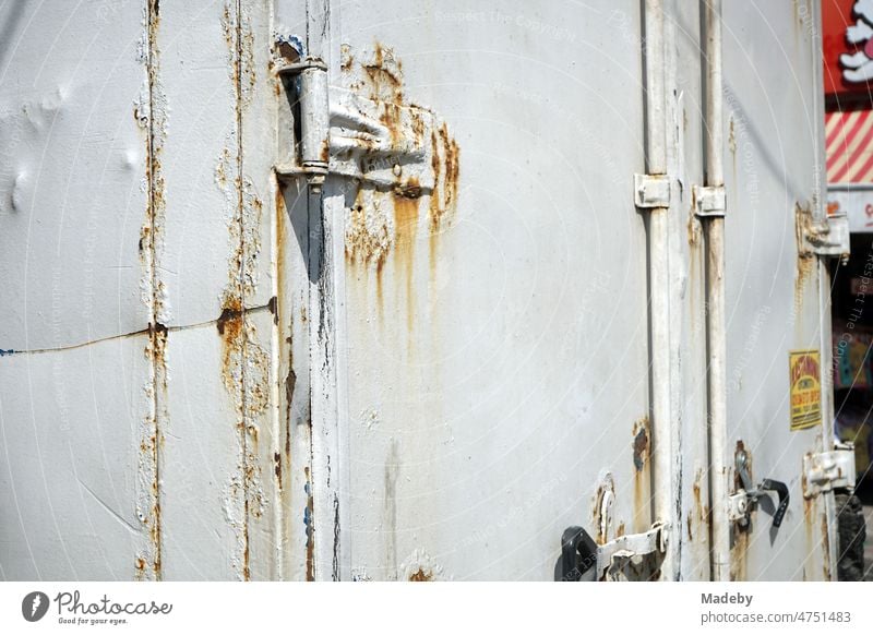 Rusty hinges on the doors of the box body of an old truck in natural colors in the summer sunshine in Adapazari, Sakarya province, Turkey Authentic Contrast