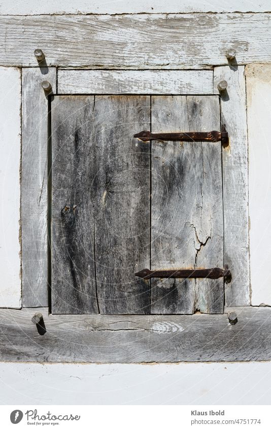 Weathered wooden shutter in a half-timbered house Wood Board Half-timbered house half-timbered building Old Aging weathered wood Iron Rust rusty Abstract Closed