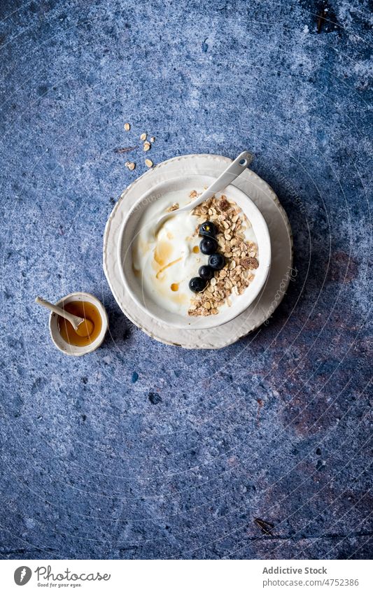 Muesli with yogurt and blueberries muesli blueberry breakfast morning honey table healthy food oatmeal bowl portion nutrition vitamin diet fresh marble organic