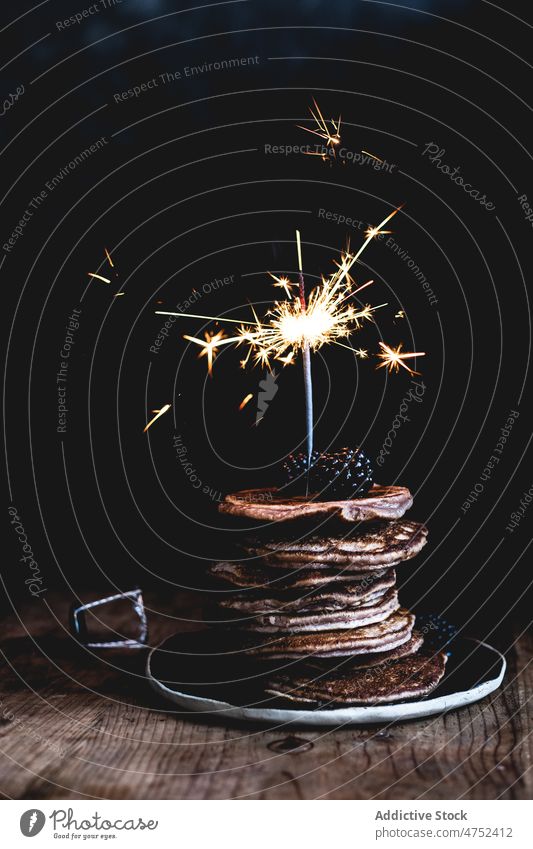 Chocolate pancakes with blackberries sparkler chocolate blackberry dark holiday celebrate sweet table breakfast dessert food portion delicious indulge stack