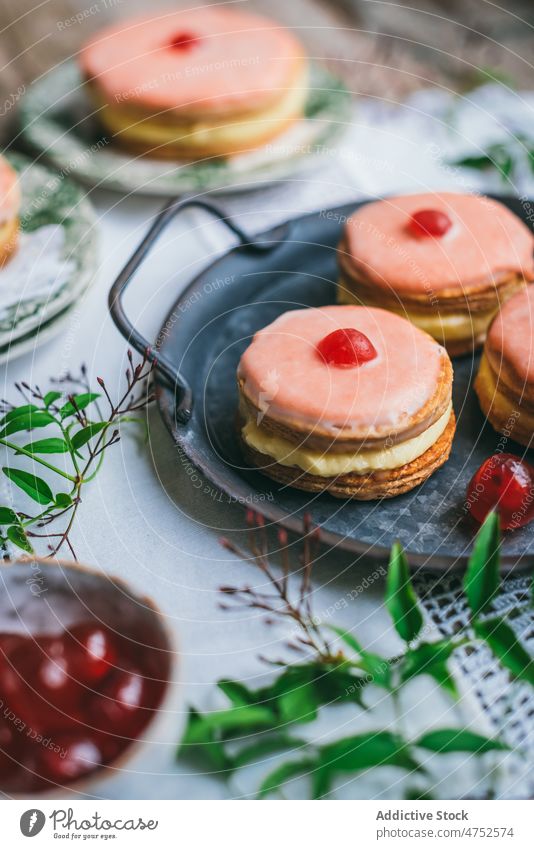 Yummy cakes near red carnations dessert jelly icing flower confectionery sweet flavor table tasty serve tray portion delicious food pastry appetizing fresh