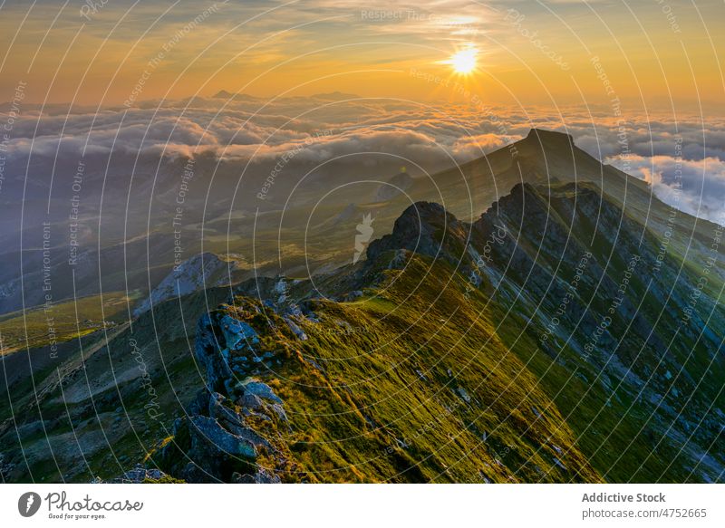 Mountain ridge and clouds in morning mountain sunrise sunshine sky picturesque scenic highland bright landscape nature breathtaking range atmosphere weather