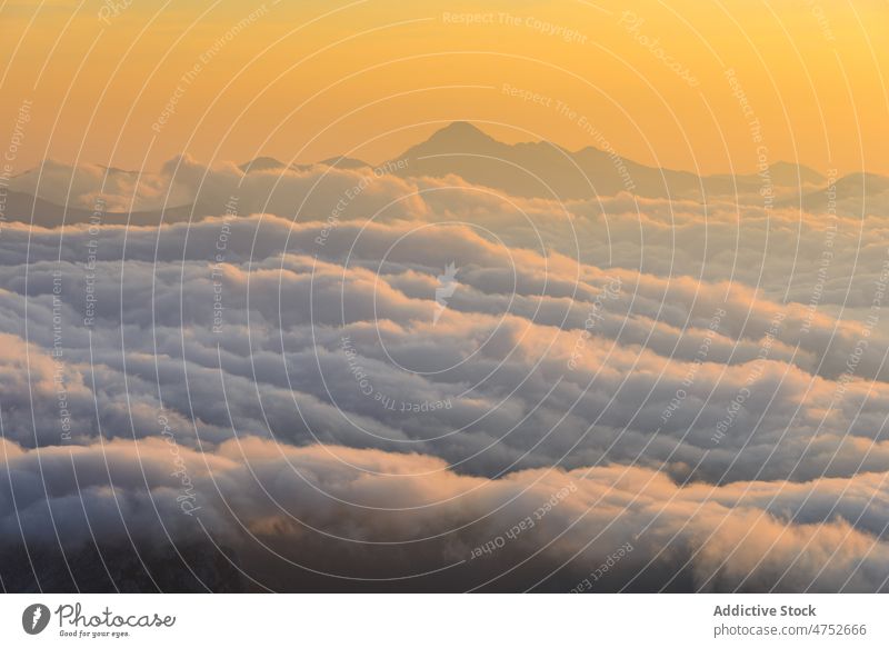 Clouds and mountains at sunrise cloud peak morning sky weather early heaven ridge nature breathtaking dawn picturesque range scenic calm atmosphere highland