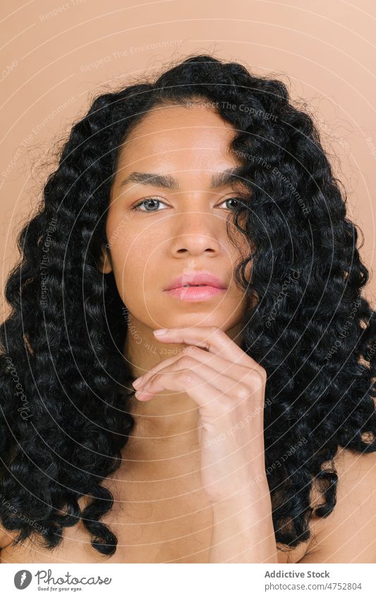 Pensive woman in light studio thoughtful pensive wistful think dreamy appearance feminine style trendy hairstyle curly hair attractive female charming calm