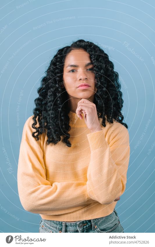 Pensive black woman looking away appearance hairstyle feminine trendy studio attractive female charming portrait african american lady beautiful light funny