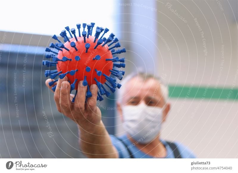 The Corona virus from the workshop | Man with mask proudly holds the virus in his hand Virus 3D corona corona thoughts covid-19 Handcrafts Self-made Dangerous