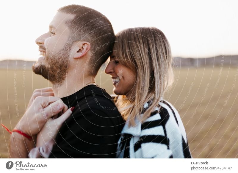 Close up couple hugging and looking at camera in the countryside embraced. Boyfriend and girlfriend in love close up two people embracing journey weekend man