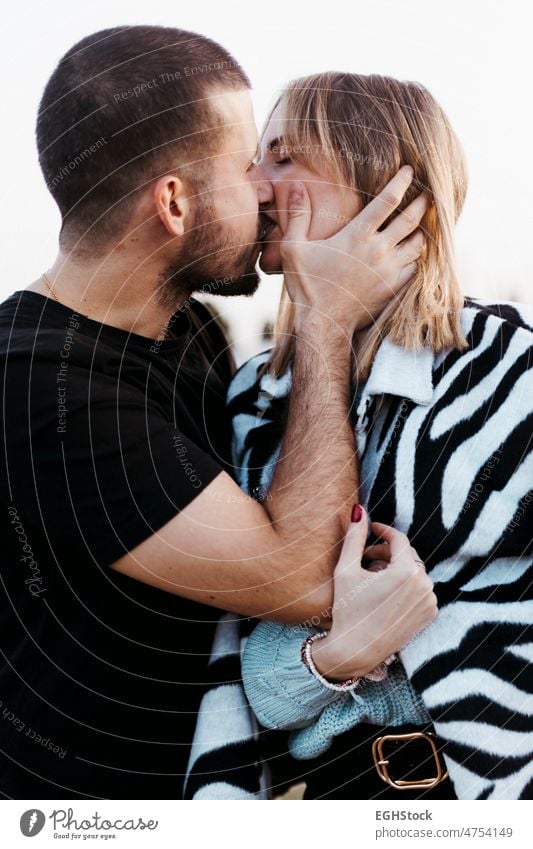 Couple kissing in the countryside embraced. Boyfriend and girlfriend in love hugging couple embracing journey weekend people man woman adult nature outdoors