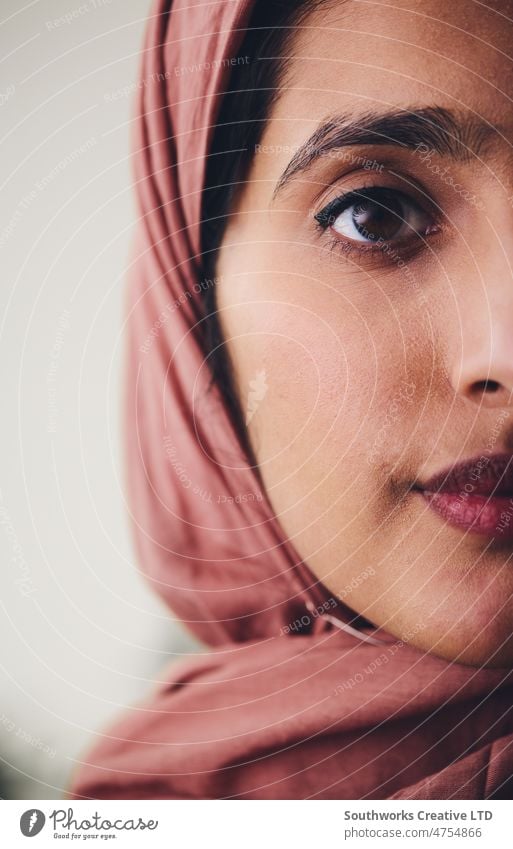 Cropped portrait of young Muslim woman wearing hijab looking towards camera with confident expression muslim middle eastern crop hajab one pride