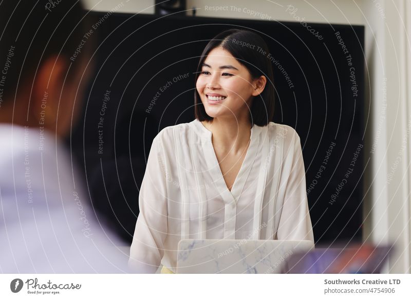 Portrait of cheerful mid adult Chinese businesswoman smiling in business meeting with confident expression women portrait chinese smile asian one people indoors