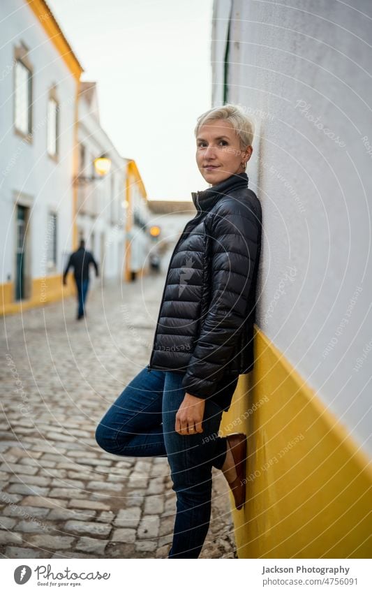 Portrait of blond modern woman in urban settings portrait city middle age faro historical relaxing standing downtown building happiness algarve destination