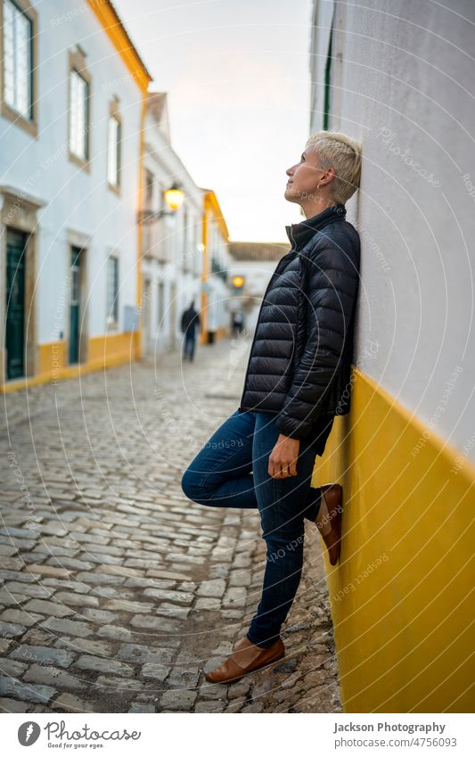 Portrait of blond modern woman in urban settings portrait city middle age faro historical relaxing standing downtown building happiness algarve destination