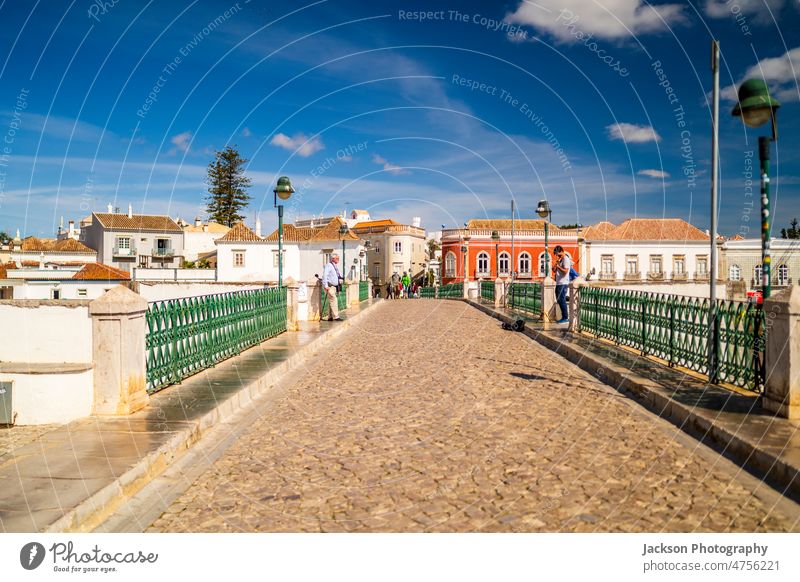 Beautiful cityscape of historic Tavira by Gilao river, Algarve, Portugal tourist tourists people tavira algarve bridge architecture home outdoors european