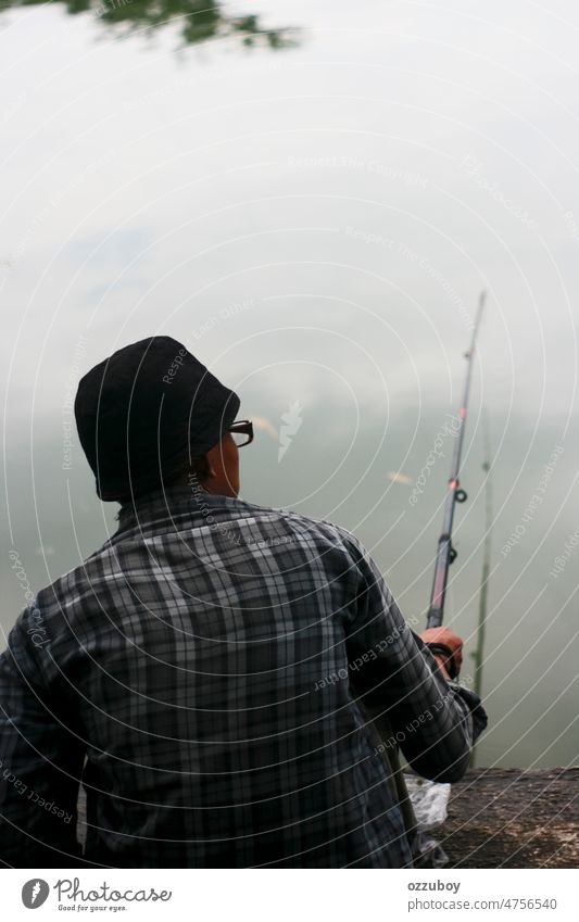 Rear view of person fishing in the pond nature lake water man fisherman leisure outdoor summer hobby male rod back background recreation catch equipment