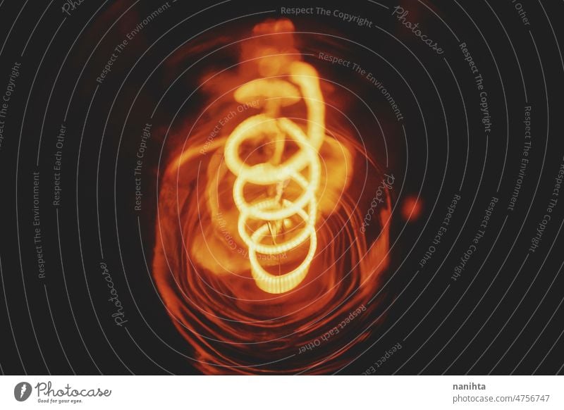 Chaotic shapes of a led light filament abstract surreal otherwordly tungsten bulb electricity magical weird curve painting spiral chaos sparkles particles view