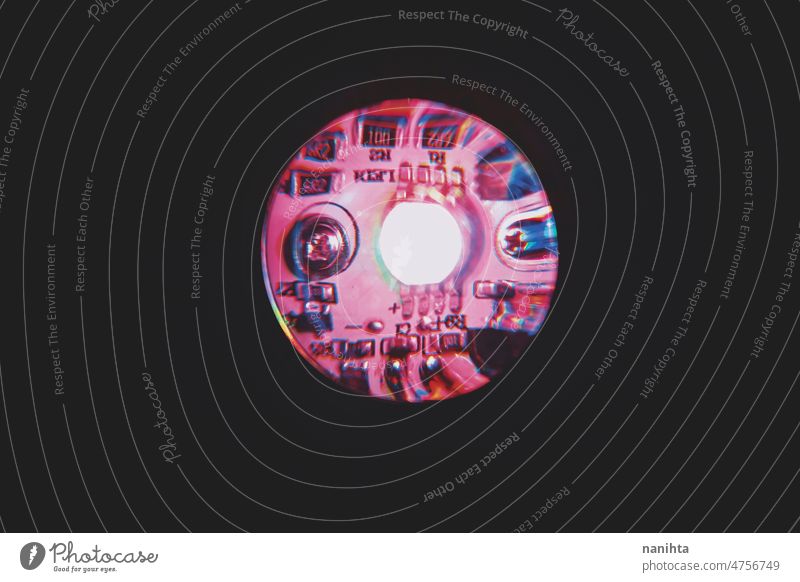 Isolated on dark circuit of a colorful lamp technology chip microchip led light bulb rainbow mechanic screw bolt black darkness macro lens glass magnyfing