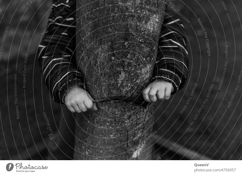 Child hugging a tree in black and white Infancy Embrace Black & white photo White Monochrome Dark Environment Tree Environmental protection Nature Contrast