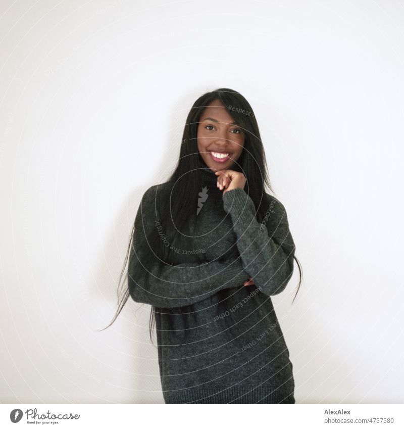 Young beautiful long haired woman standing in front of white wall smiling at camera Woman Young woman pretty Beauty & Beauty Graceful Joy Friendliness kind