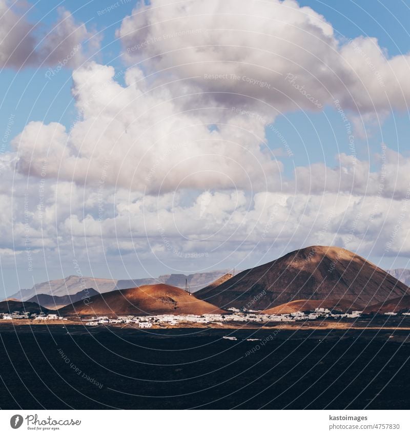 Amazing panoramic landscape of volcano craters in Timanfaya national park. Popular touristic attraction in Lanzarote island, Canary islans, Spain. Artistic picture. Beauty world. Travel concept.