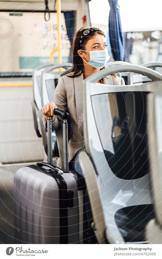 A young woman wearing mask commuting by the public bus traveler pandemic adult trip auto vehicle casual smile drive sitting happy journey attractive