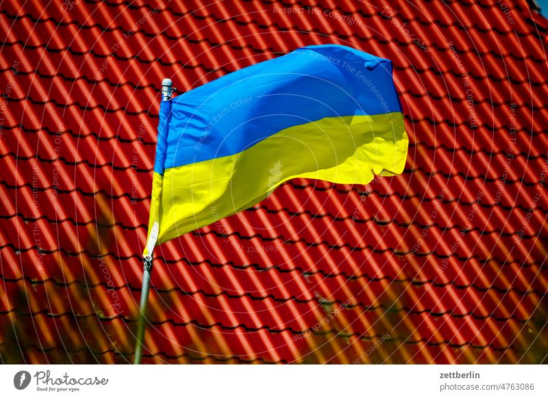 Urain flag in front of a red roof Berlin Germany Flag Building Capital city House (Residential Structure) emblem Life nation Nationality Solidarity Town