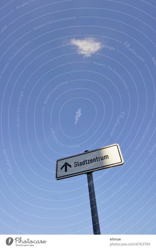 Sign - city center - with arrow pointing upwards on metal pole against blue sky with single white cloud from frog perspective Downtown sign Signage Sky blue