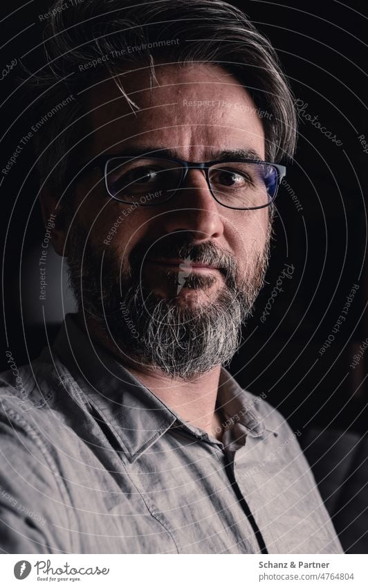 Portrait of man with glasses and beard smiling timidly Man portrait Dark Facial hair Shirt Eyeglasses grin Smiling Looking into the camera