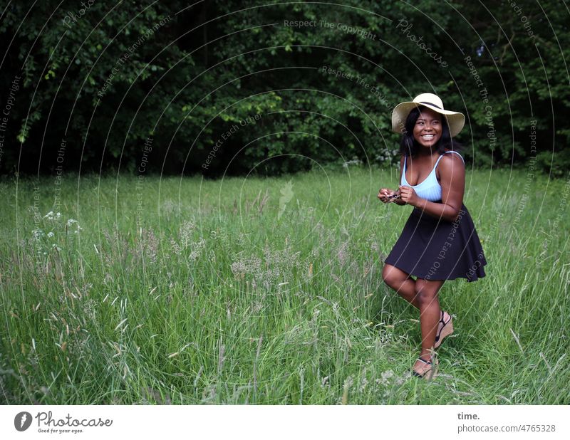 Woman in green Black-haired Long-haired Hat Skirt T-shirt Forest Meadow Esthetic Self-confident pretty heels Inspiration Full-length portrait Nature Feminine