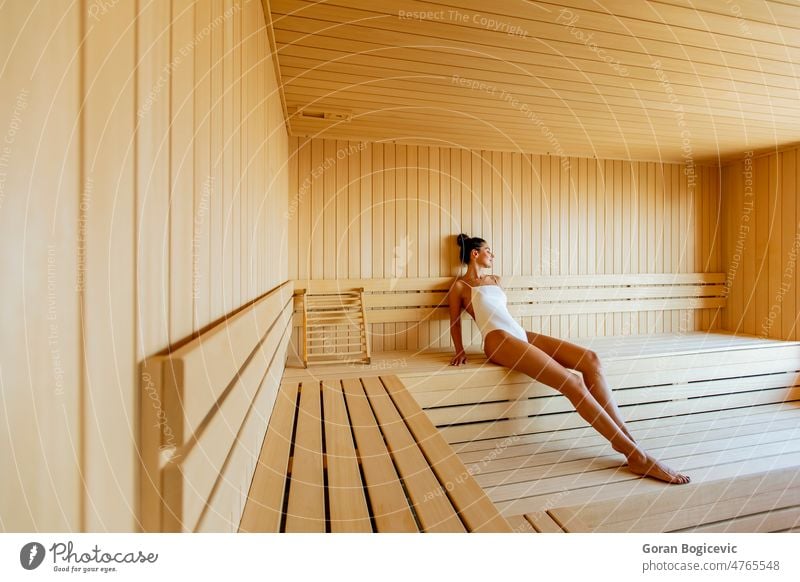 Young woman relaxing in the sauna activity adult attractive bath bathhouse beauty bench body caucasian comfortable cute enjoyment female health healthy heat