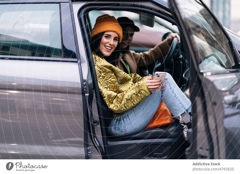 Smiling women sitting in car friend commute street city bonding spend time pastime leisure appearance feminine female cheerful glad positive smile content