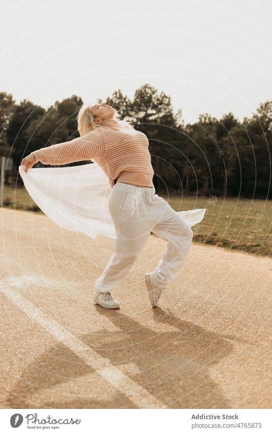 Lady performing dance on asphalt road in countryside woman roadway enjoy freedom dream carefree forest nature tree spread arms style sheet woods woodland